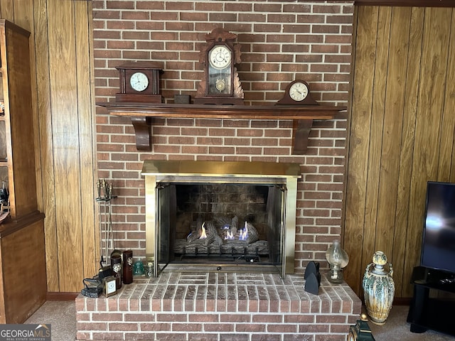 details featuring carpet, a brick fireplace, and wooden walls