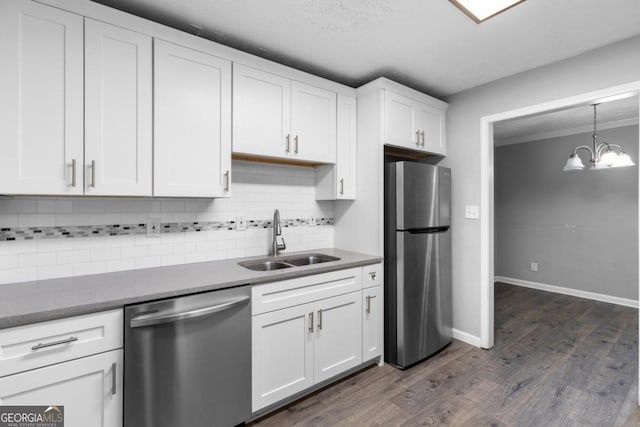 kitchen featuring white cabinets, sink, dark hardwood / wood-style floors, tasteful backsplash, and stainless steel appliances