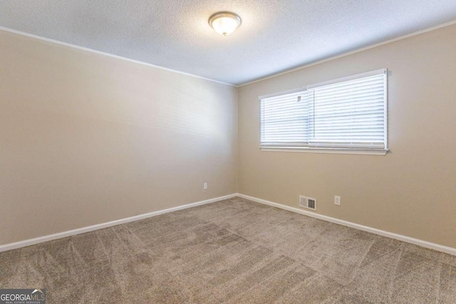 carpeted empty room with a textured ceiling