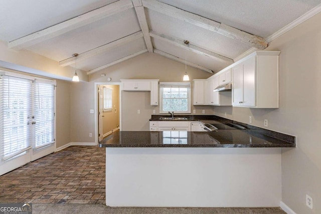 kitchen featuring pendant lighting, white cabinetry, kitchen peninsula, and sink