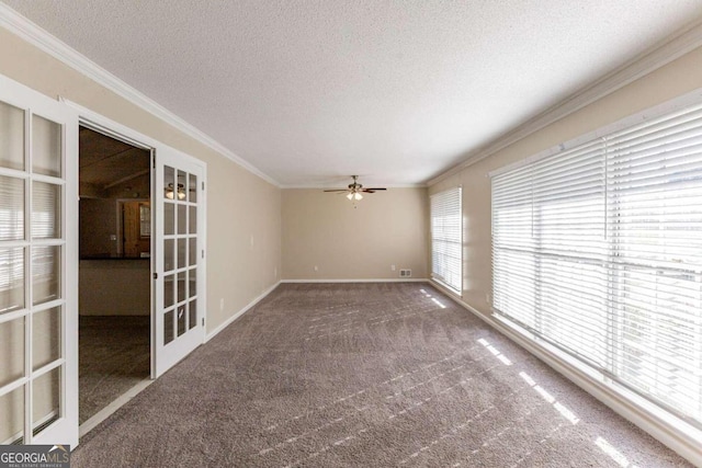 carpeted spare room featuring french doors, ceiling fan, crown molding, and a textured ceiling