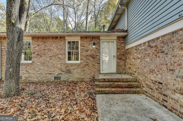 entrance to property featuring a patio