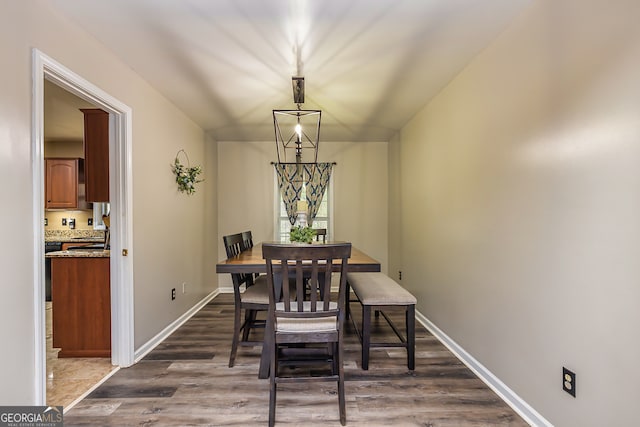 dining space with dark hardwood / wood-style floors