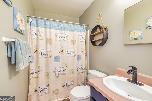 bathroom featuring a shower with curtain, vanity, and toilet