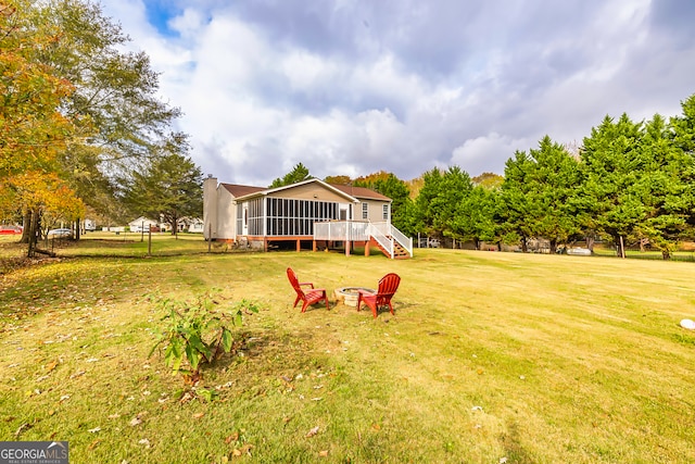 view of yard with a deck and a sunroom