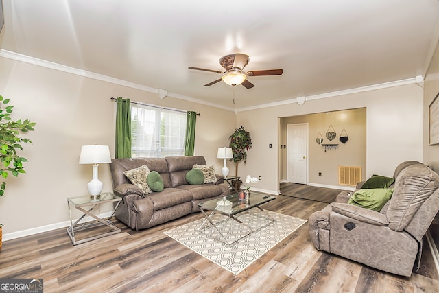 living room featuring hardwood / wood-style floors, ceiling fan, and crown molding