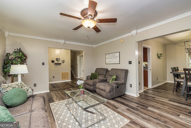 living room featuring hardwood / wood-style flooring, ceiling fan, and crown molding