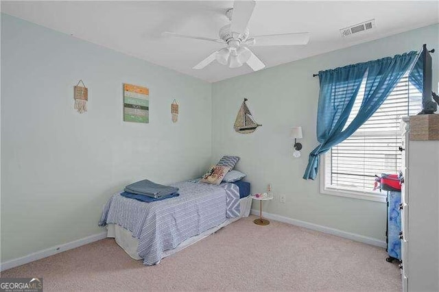 bedroom featuring ceiling fan and light carpet