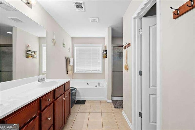 bathroom featuring tile patterned flooring, vanity, and plus walk in shower