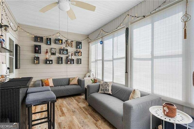 sunroom / solarium featuring ceiling fan