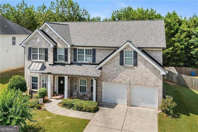 view of front of property featuring a garage and a front lawn