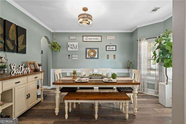 dining space with dark hardwood / wood-style floors and ornamental molding