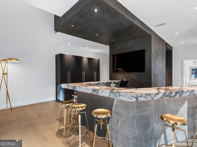 bar featuring light hardwood / wood-style flooring