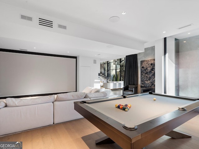 recreation room with light wood-type flooring, expansive windows, a wealth of natural light, and billiards