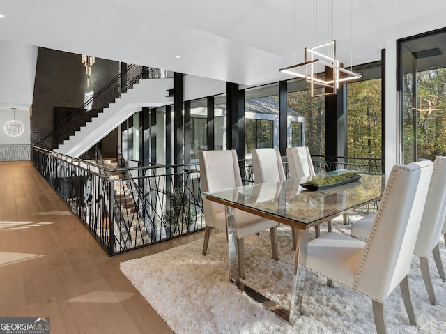 dining room with hardwood / wood-style flooring and expansive windows