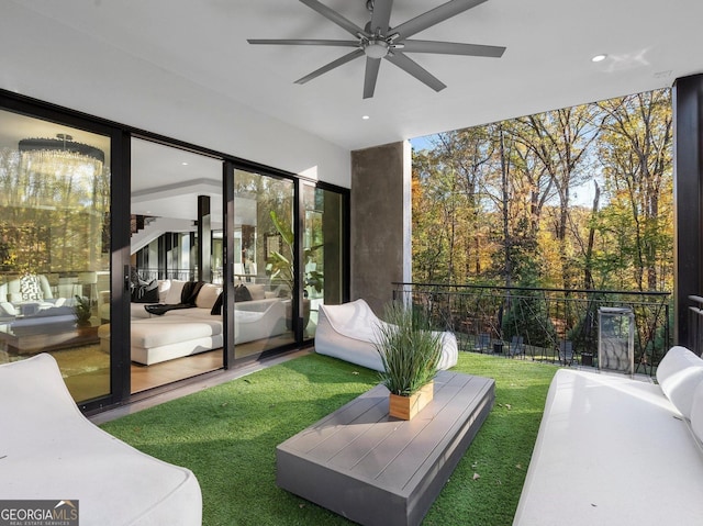 sunroom featuring ceiling fan