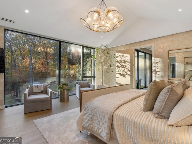 bedroom with access to outside, multiple windows, light hardwood / wood-style flooring, and vaulted ceiling