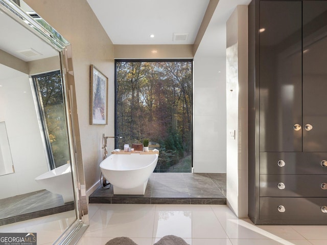 bathroom with a bathing tub and tile patterned floors