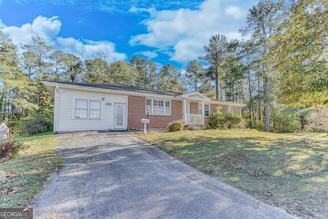 ranch-style house with a front yard and a porch