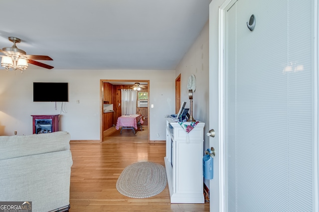 living room featuring light wood-type flooring and ceiling fan