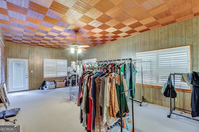 spacious closet with ceiling fan and light carpet