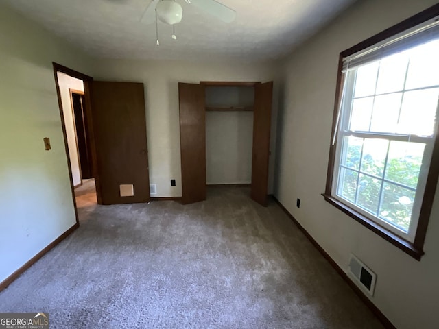 unfurnished bedroom featuring ceiling fan and carpet floors