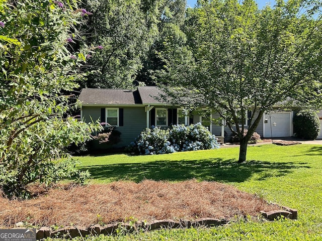 view of front facade with a garage and a front lawn