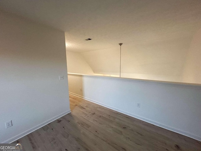 bonus room featuring hardwood / wood-style floors and lofted ceiling