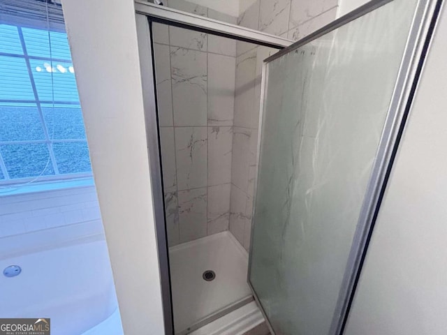 bathroom with a shower with shower door