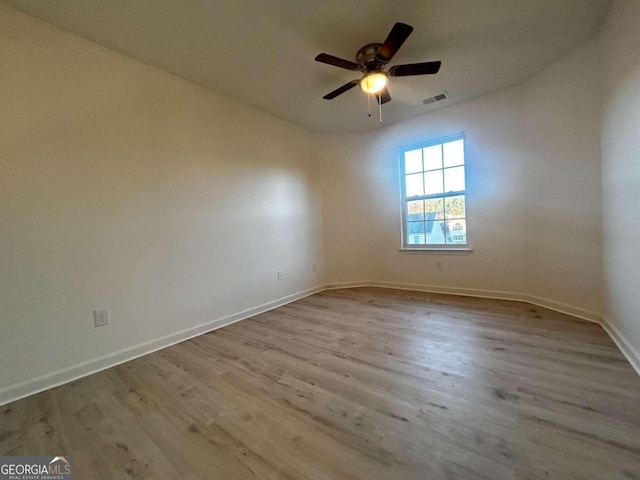 empty room featuring ceiling fan and light hardwood / wood-style floors