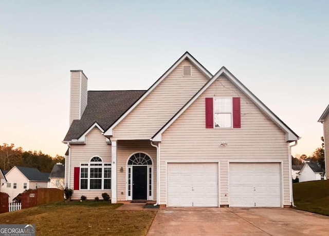 view of front of home with a lawn and a garage