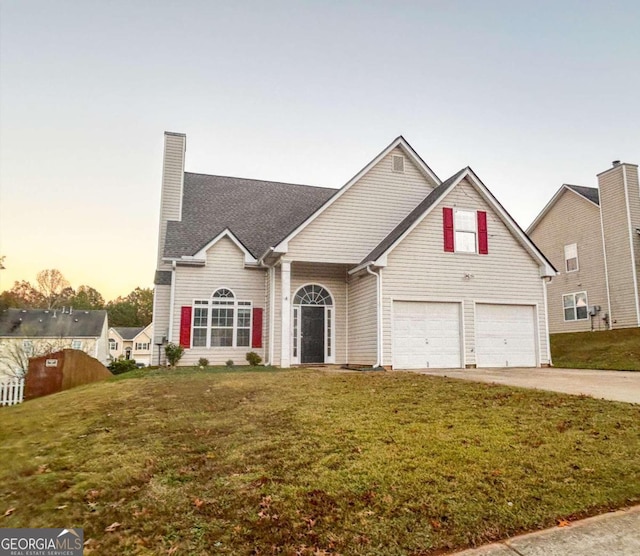 view of front facade featuring a lawn and a garage