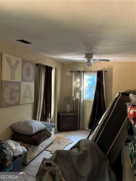 bedroom featuring ceiling fan and light colored carpet