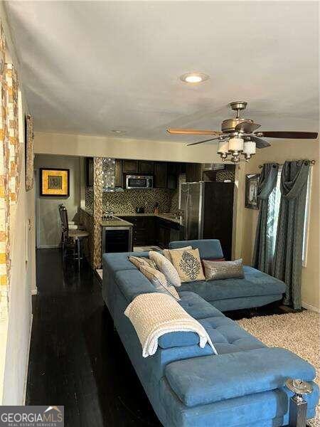 living room with ceiling fan and wood-type flooring