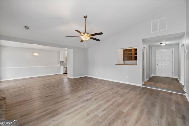 unfurnished living room featuring wood-type flooring, high vaulted ceiling, and ceiling fan