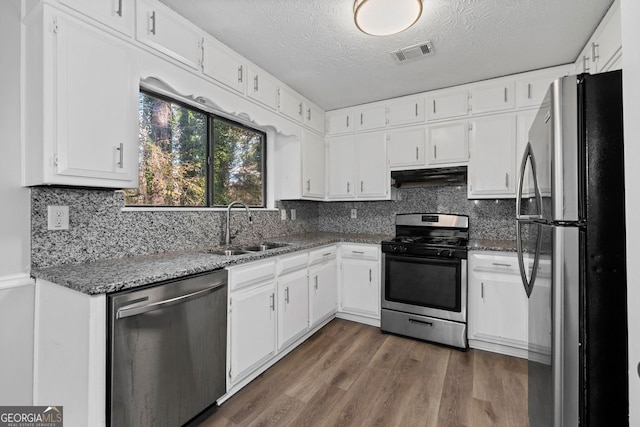 kitchen featuring white cabinets, stainless steel appliances, dark hardwood / wood-style floors, and sink