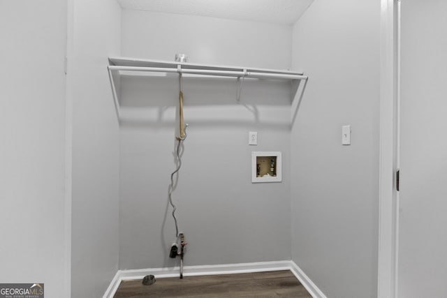 washroom with washer hookup, a textured ceiling, and dark hardwood / wood-style floors