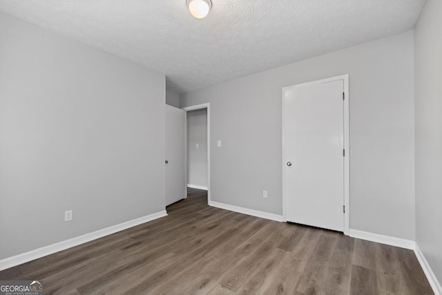 empty room featuring hardwood / wood-style floors and a textured ceiling