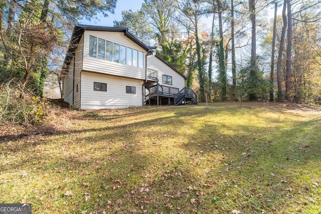 back of house with a yard and a wooden deck