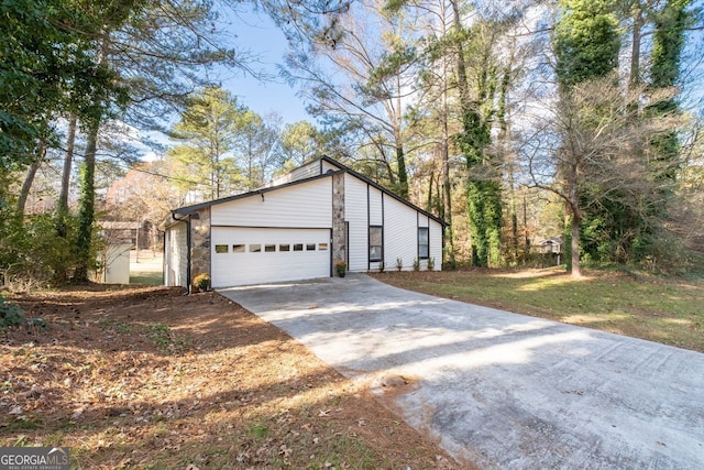 view of side of property featuring a garage and a yard