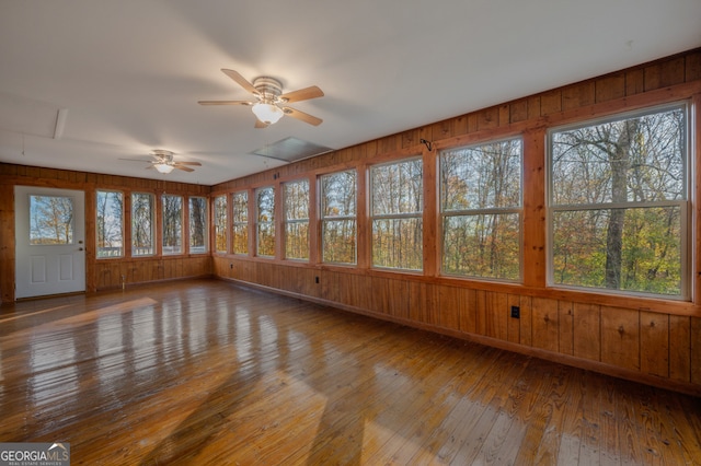 unfurnished sunroom with ceiling fan and a healthy amount of sunlight