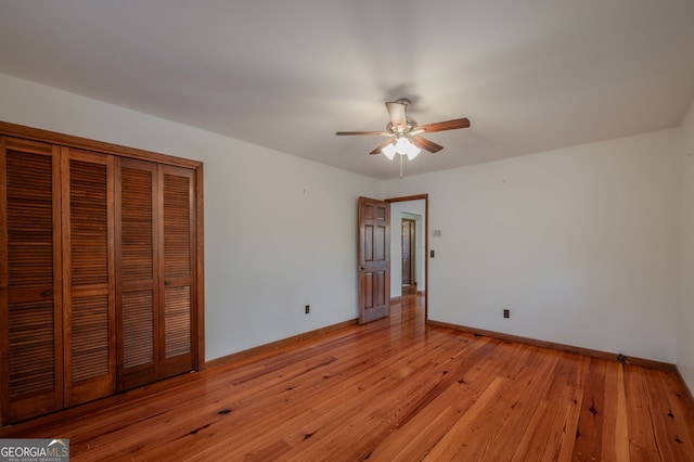 unfurnished bedroom with ceiling fan, a closet, and light hardwood / wood-style floors