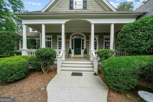 view of exterior entry with covered porch