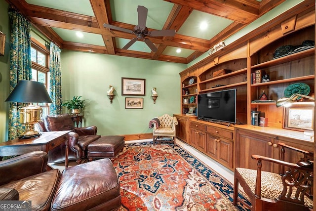 living room with beamed ceiling, ceiling fan, crown molding, and coffered ceiling