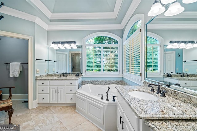 bathroom with a bathing tub, vanity, ornamental molding, and a wealth of natural light