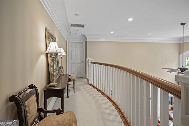 hallway with light colored carpet and ornamental molding