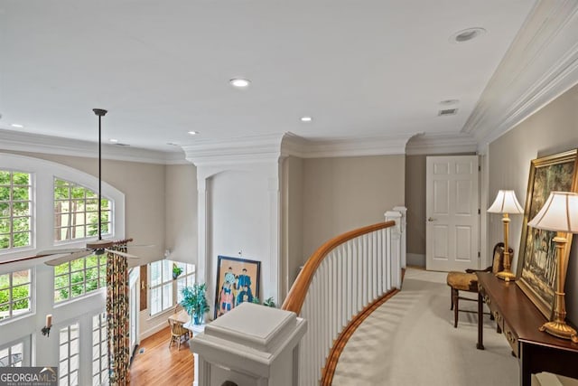 corridor featuring light hardwood / wood-style flooring and ornamental molding