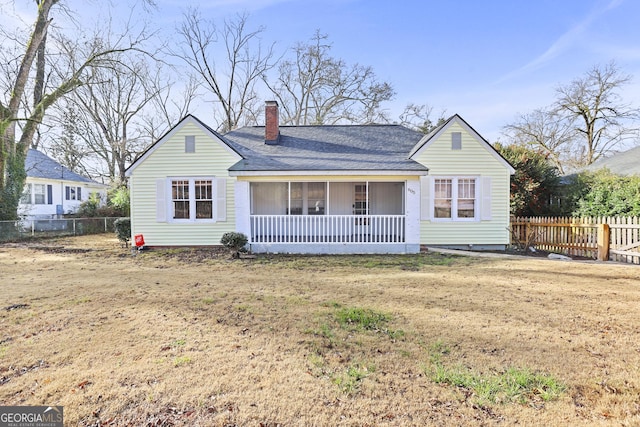 ranch-style house with a front yard and covered porch