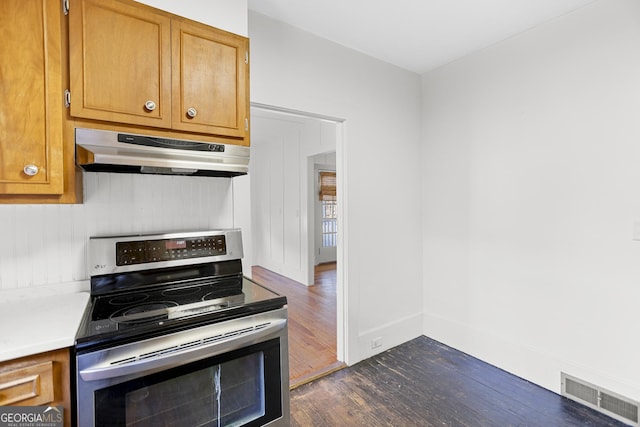 kitchen featuring dark wood-type flooring and electric range