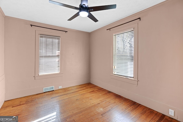 spare room with crown molding, light hardwood / wood-style flooring, and ceiling fan